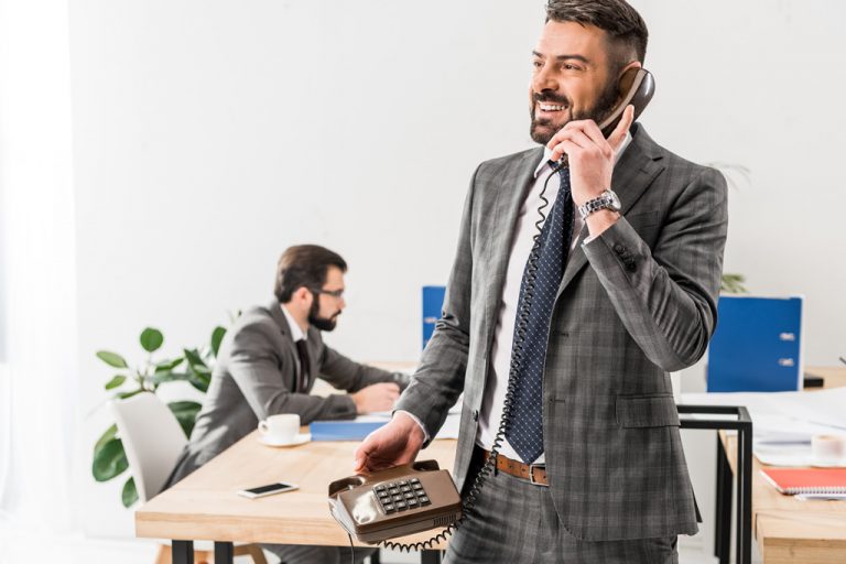 men at the office talking at the phone