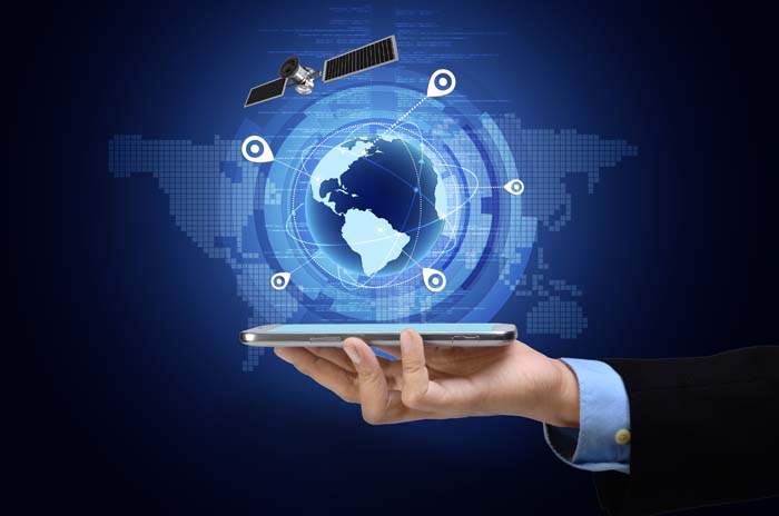 Hand holding phone with tracking abilities displayed around a globe