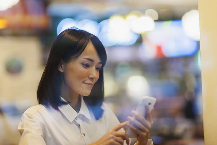 An image of a woman getting a Taiwan virtual phone number.