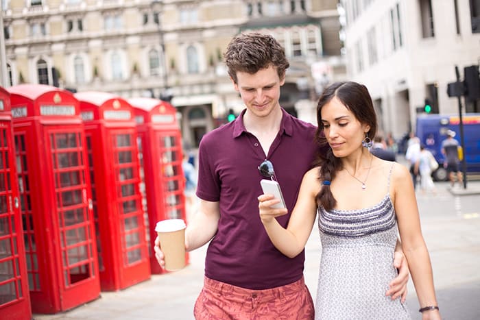 Image of two people getting UK virtual phone numbers.